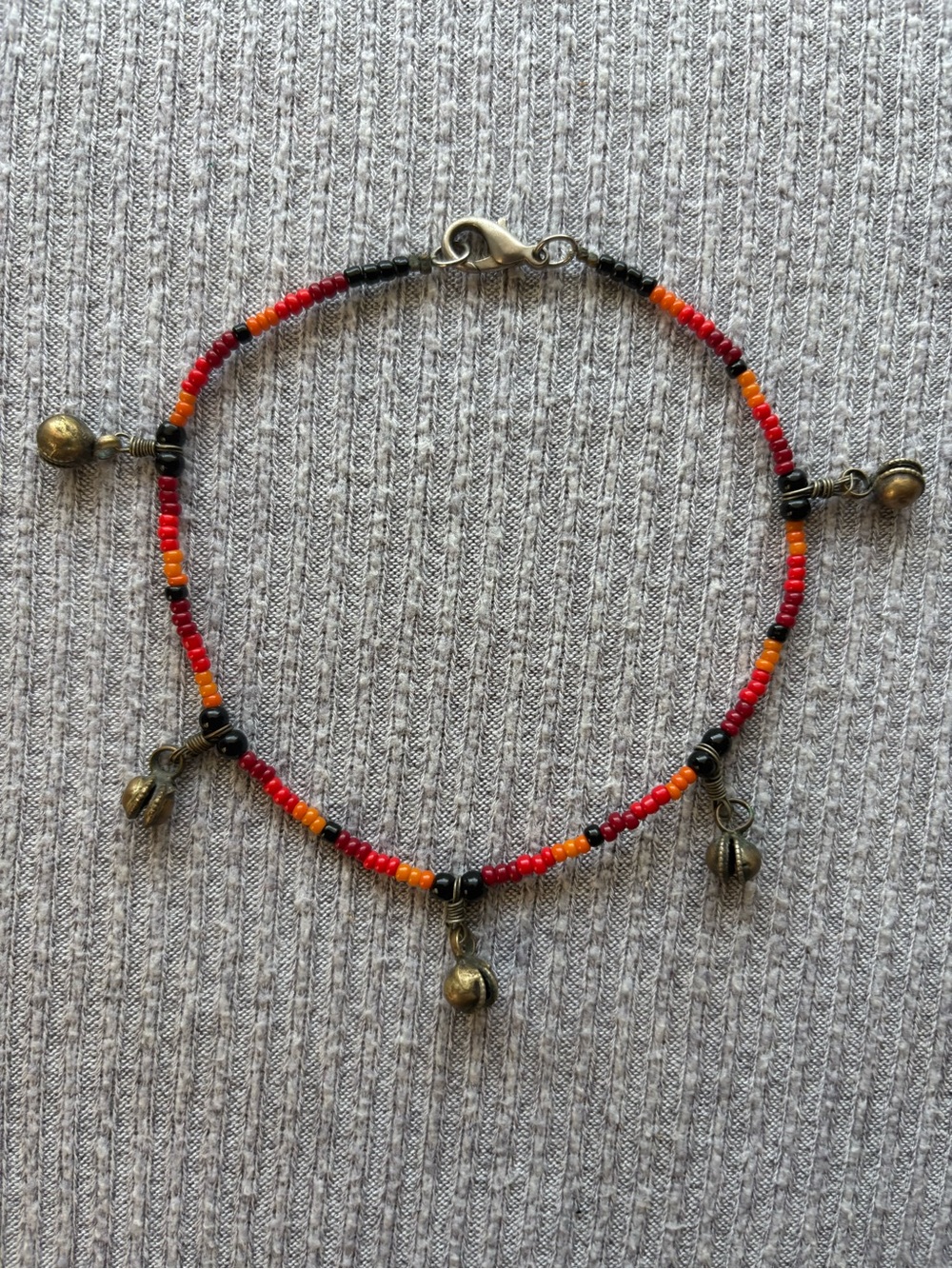 Vintage black, brown, red & orange microbeaded anklet w bronze tone bells
